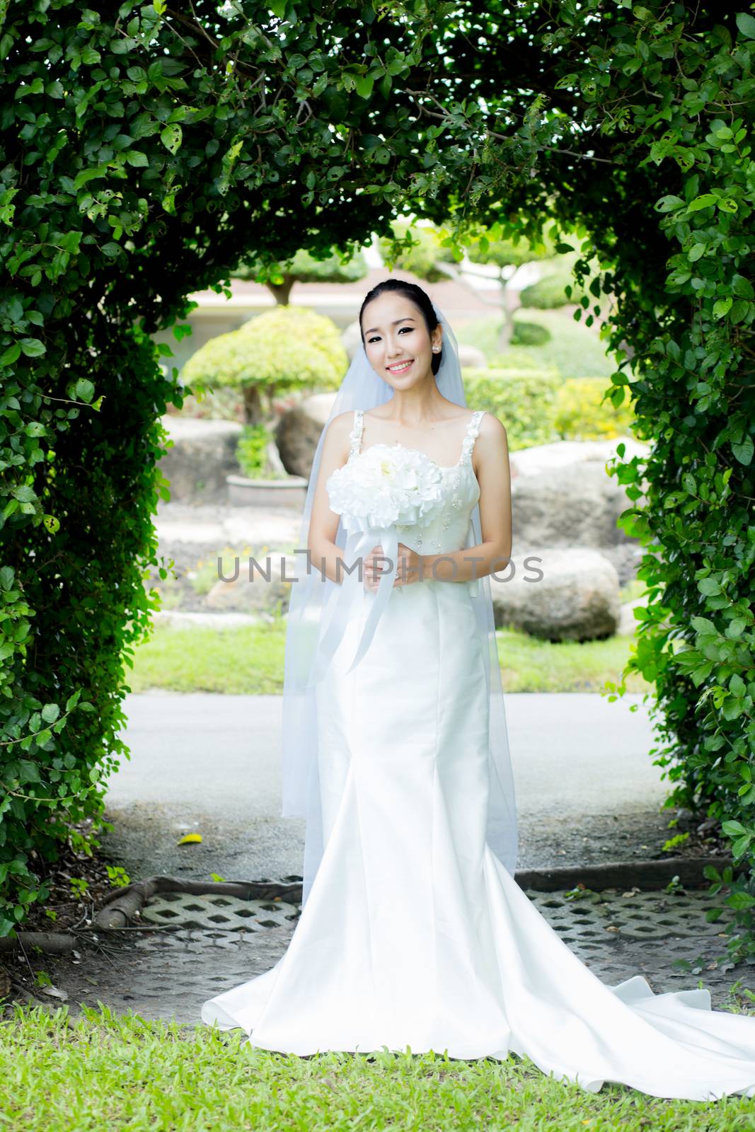 beautiful young woman on wedding day in white dress in the garden - Female portrait in the park - Selective focus.