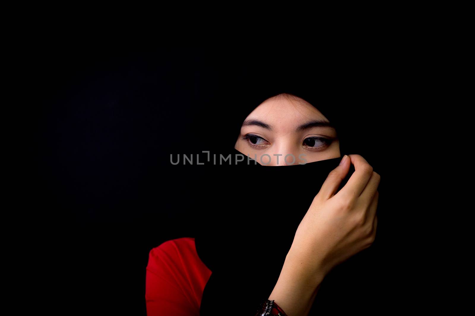 beautiful mysterious young woman wearing scarf close up.