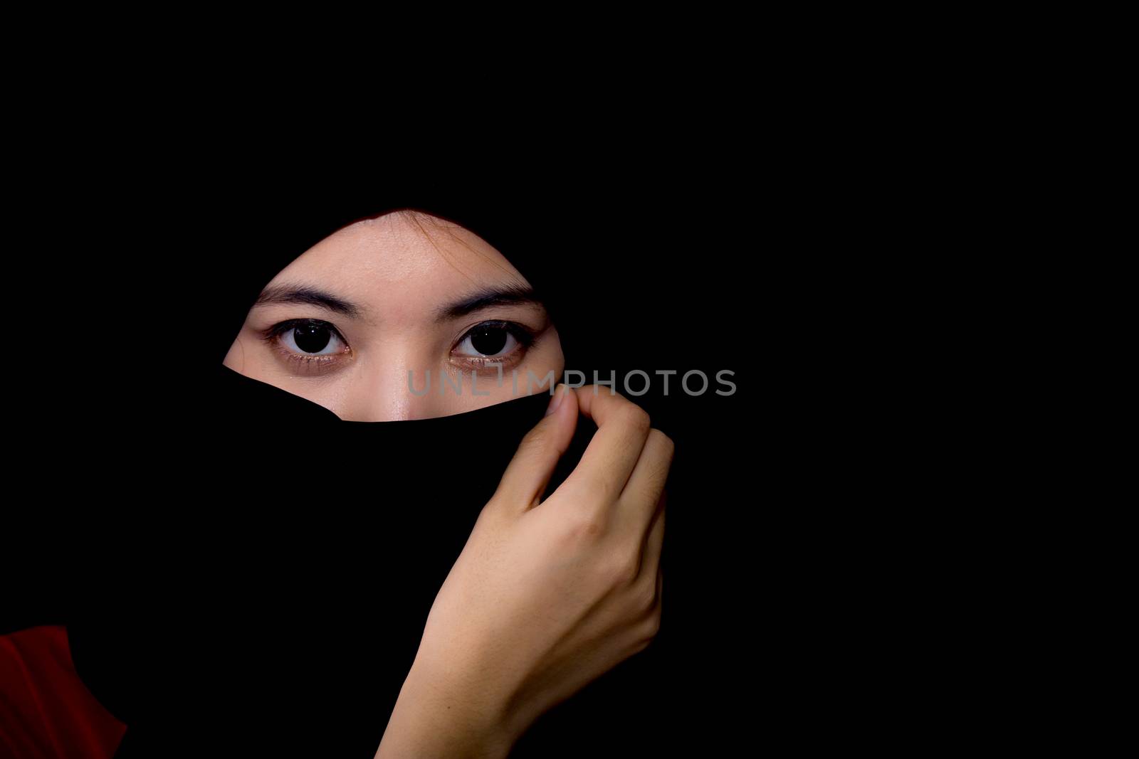 beautiful mysterious young woman wearing scarf close up.