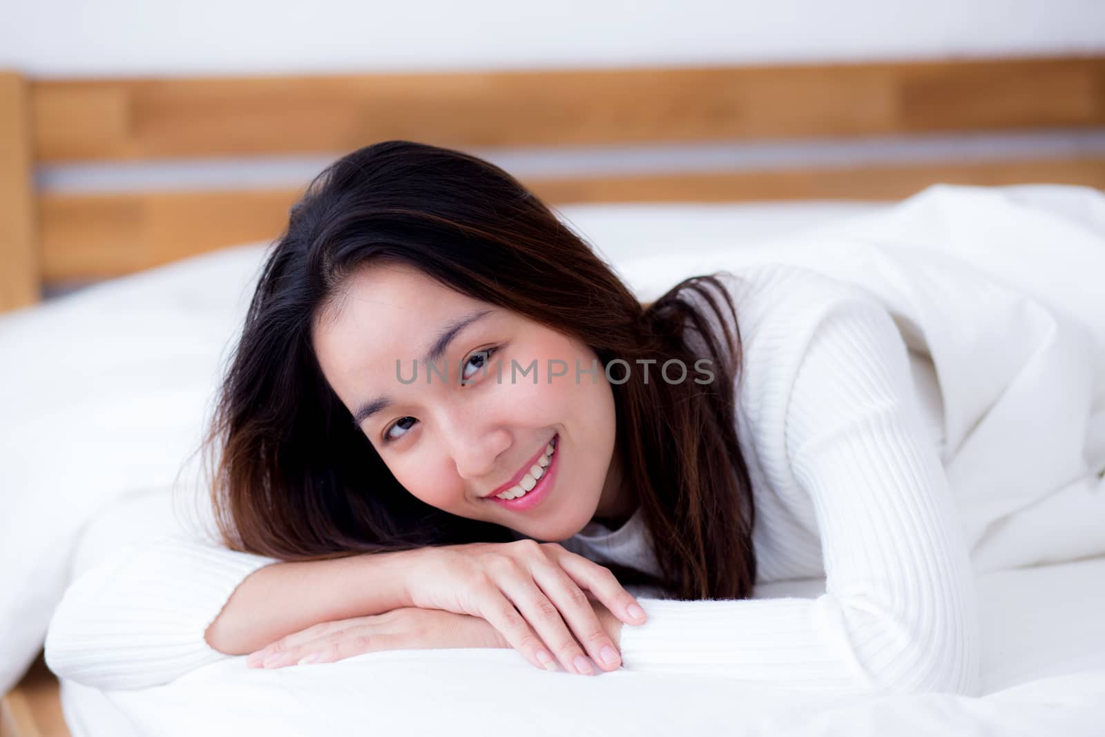 woman beautiful smiling woman portrait wake up early morning after sleeping and lying in bed.
