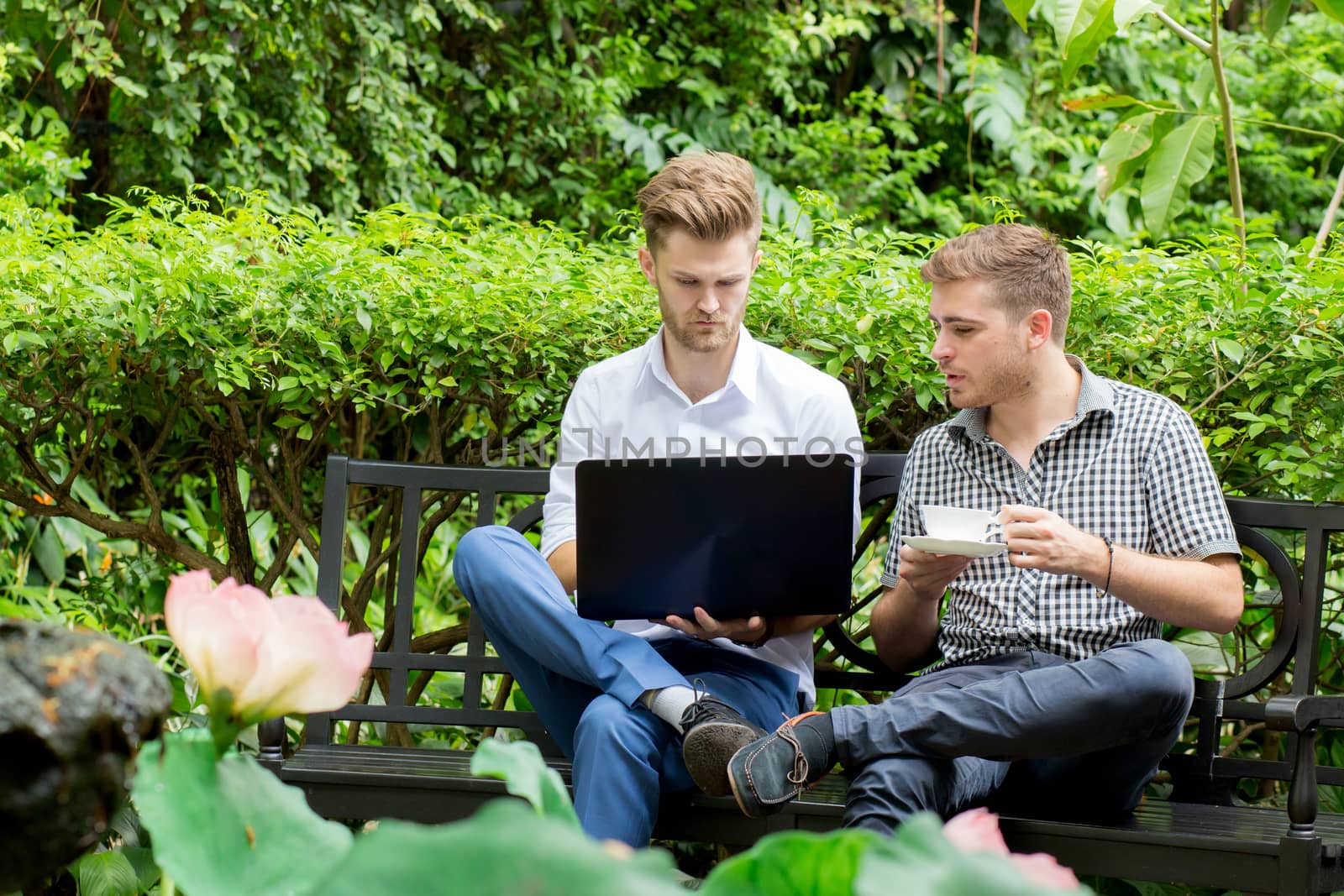 Two business people use of the notebook computer at outdoor