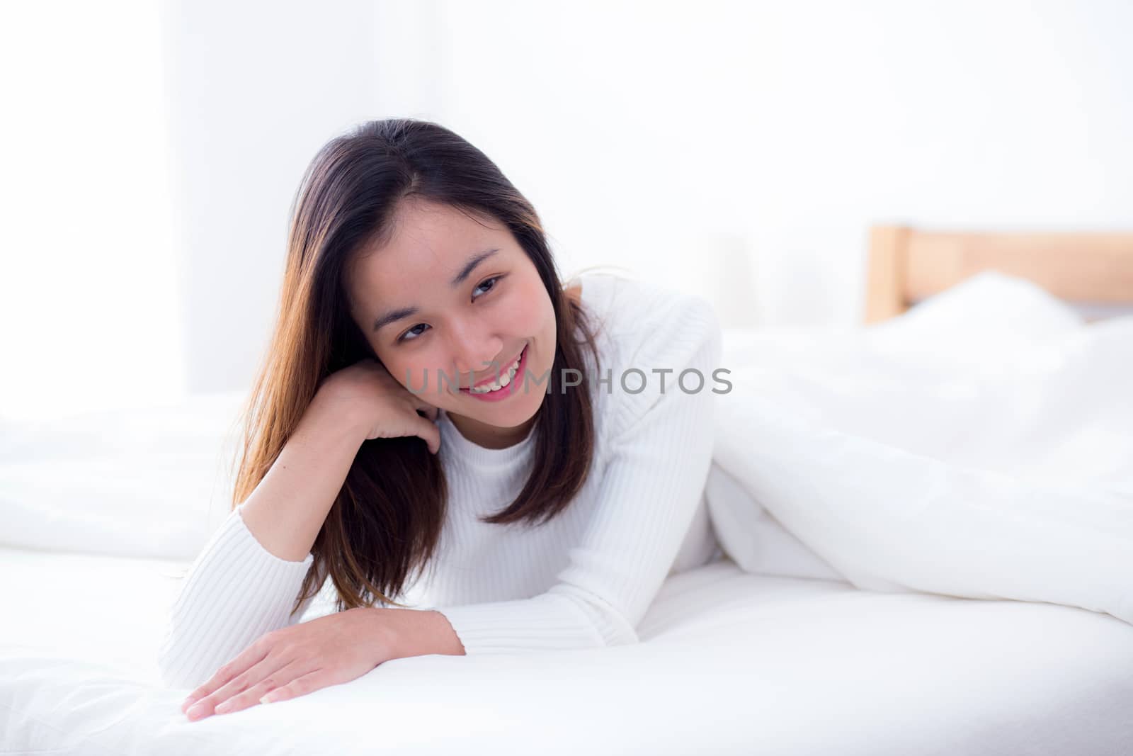 woman beautiful smiling woman portrait wake up early morning after sleeping and lying in bed.