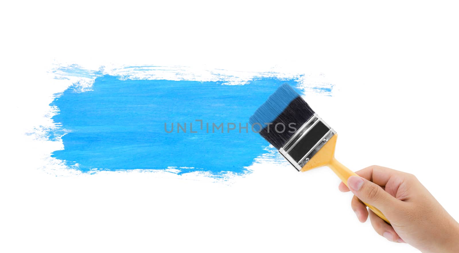 Hand hold brush painting blue with white copy space.