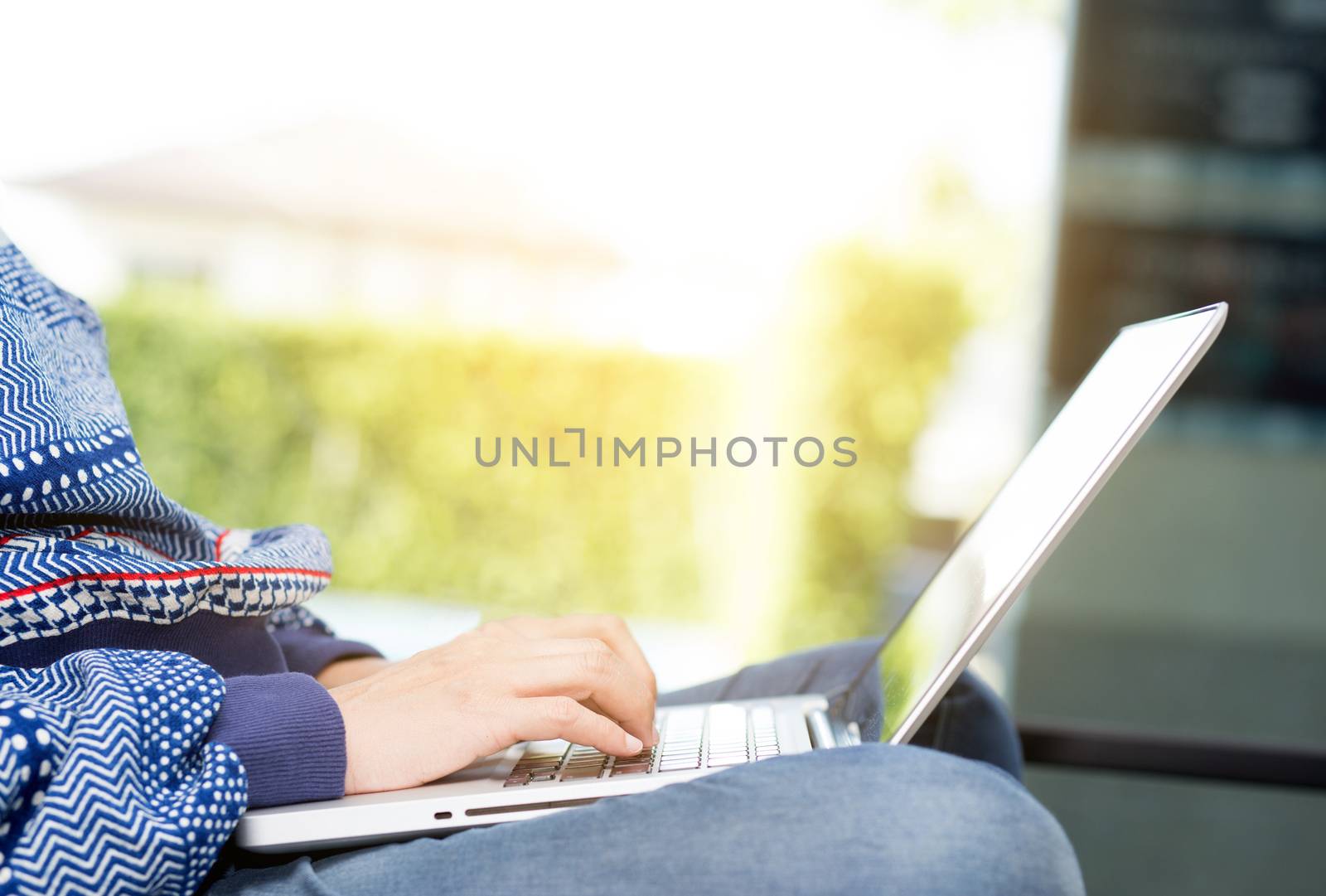 Closeup computer notebook on sofa with asian woman for work in l by nnudoo