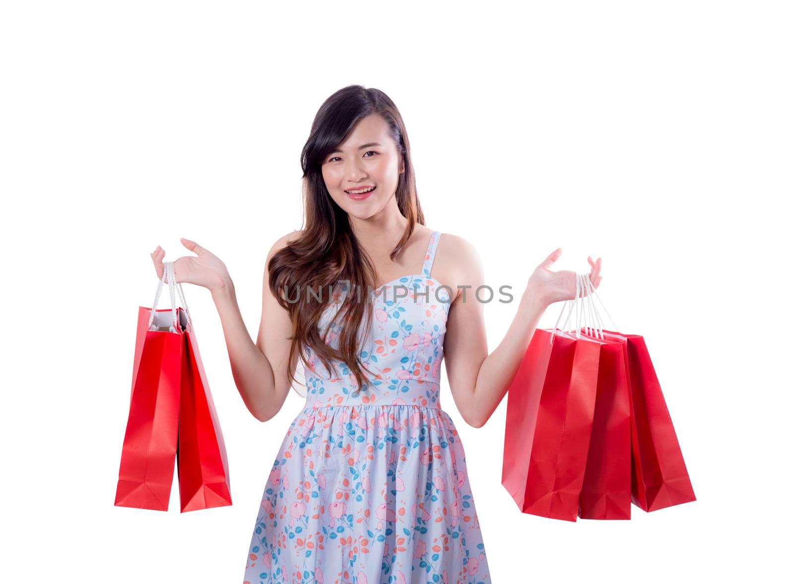 happy excited woman standing and holding colorful shopping bags isolated on a white background.
