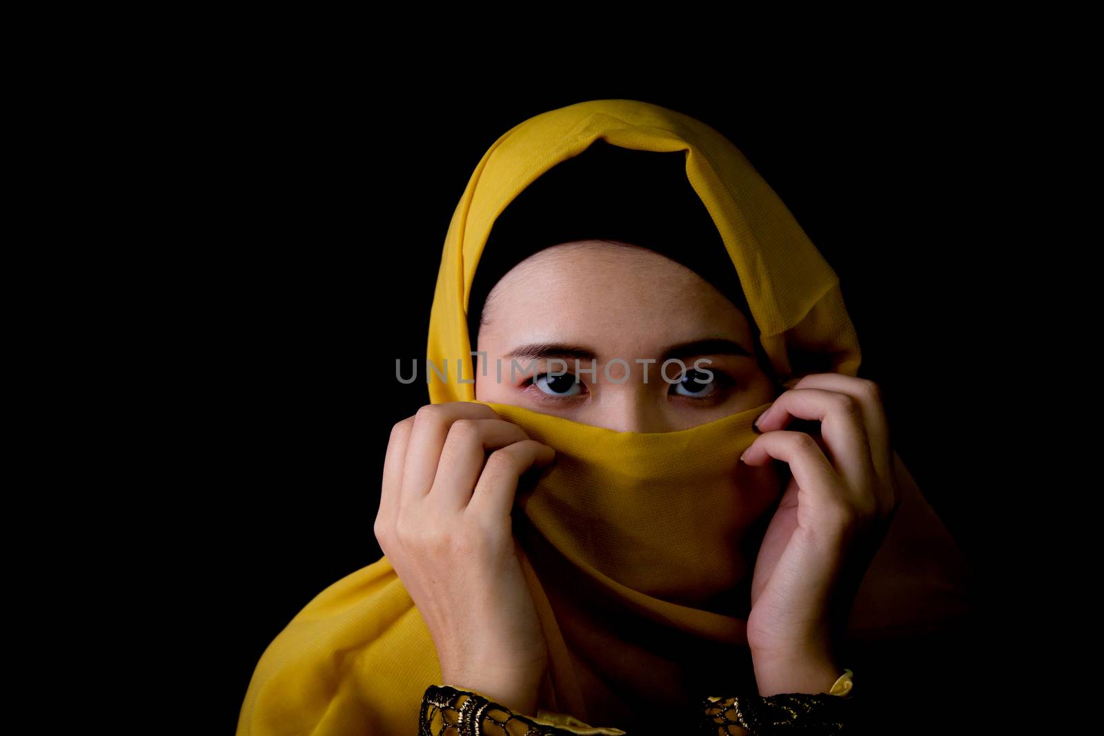 beautiful mysterious young woman wearing scarf close up.