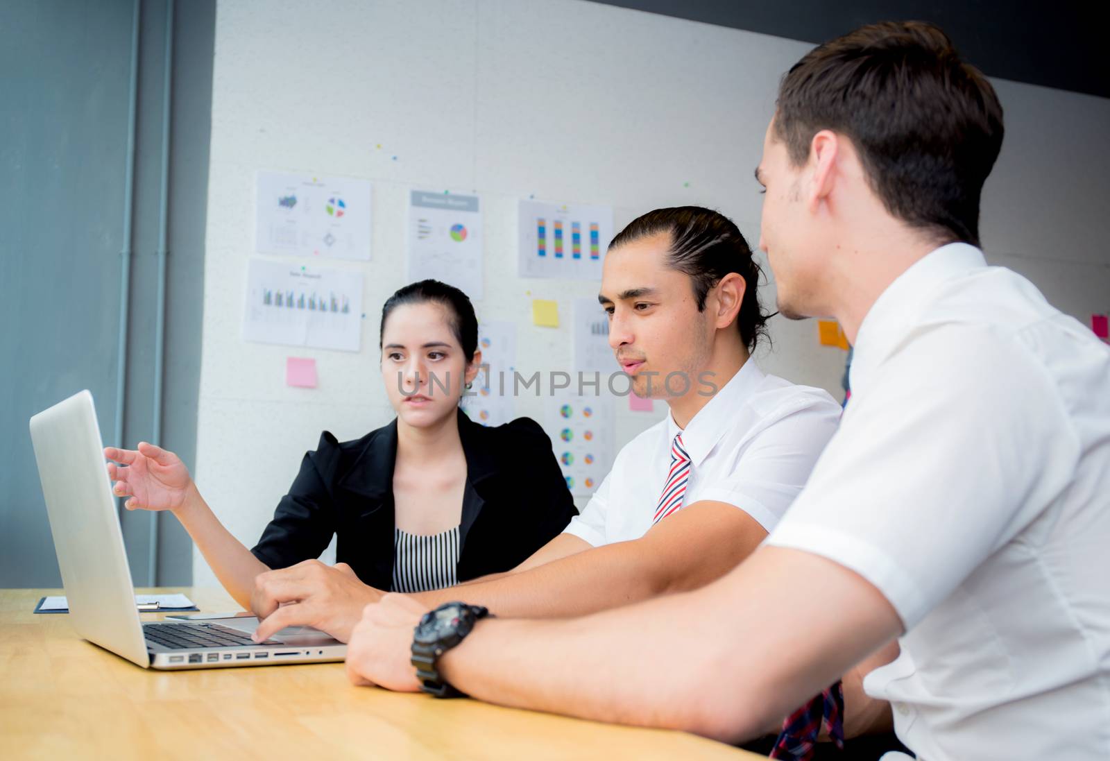 Business team having a meeting using laptop during a meeting and presents.