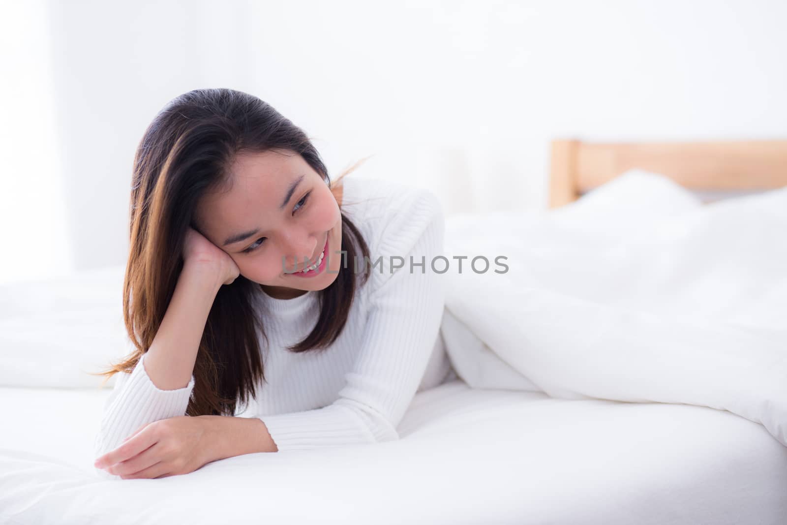 woman beautiful smiling woman portrait wake up early morning after sleeping and lying in bed.