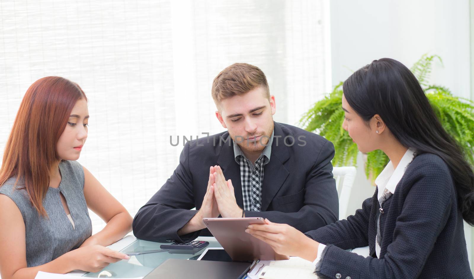 young business people making meeting and looking at tablet for analyzing marketing working at office on desk.