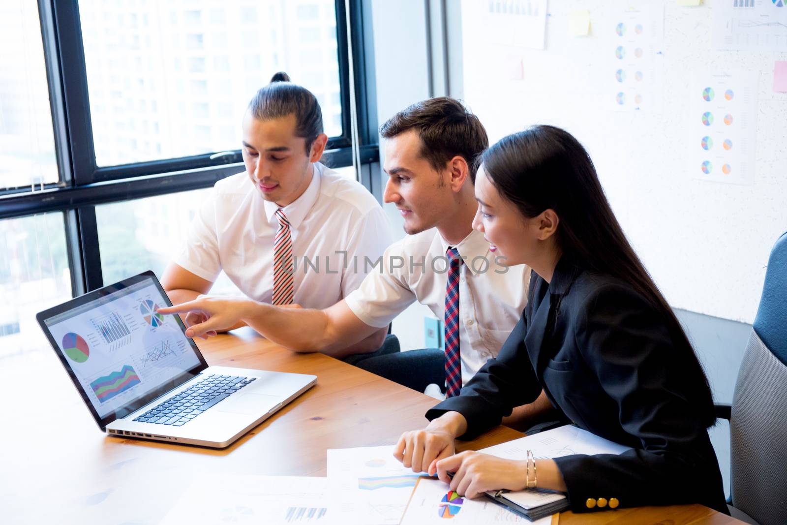 Business team having a meeting using laptop during a meeting and presents profit.