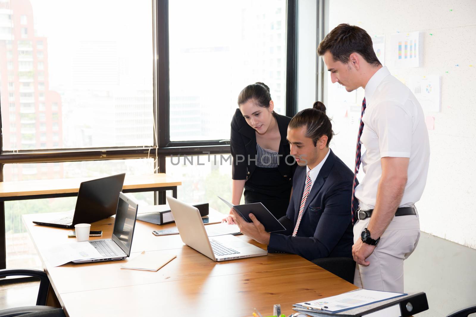 Business team having a meeting using laptop during a meeting and presents.