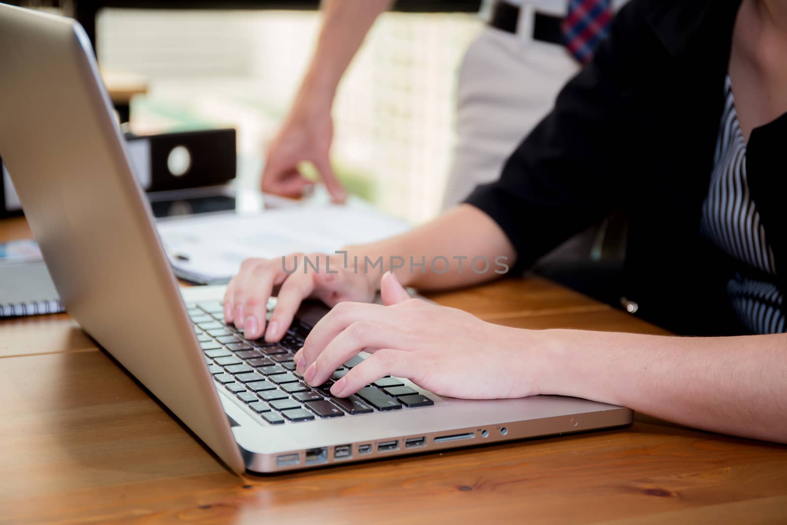 Closeup computer notebook in office with woman for work.