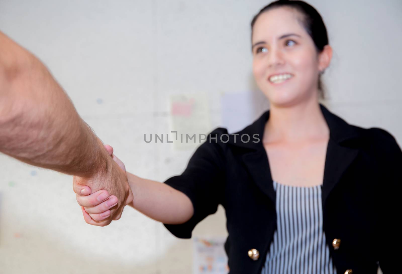 Businesswoman shaking hands, finishing up a meeting.