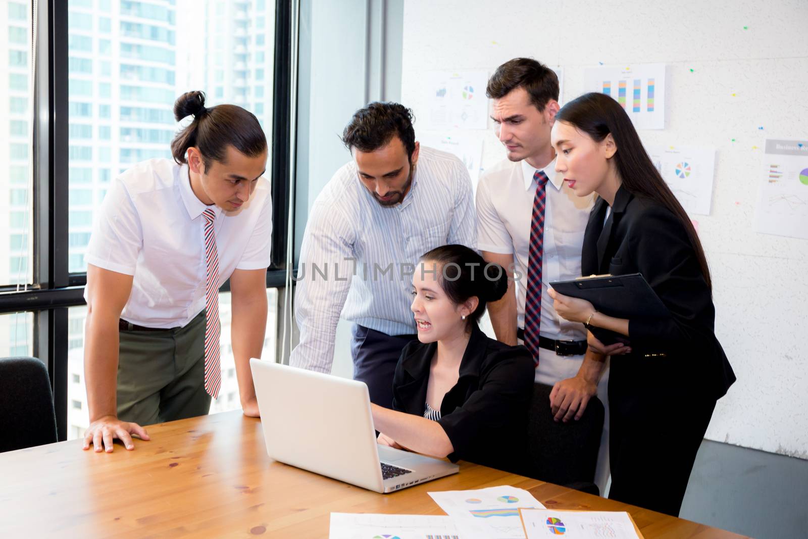 Business team having a meeting using laptop during a meeting and presents.