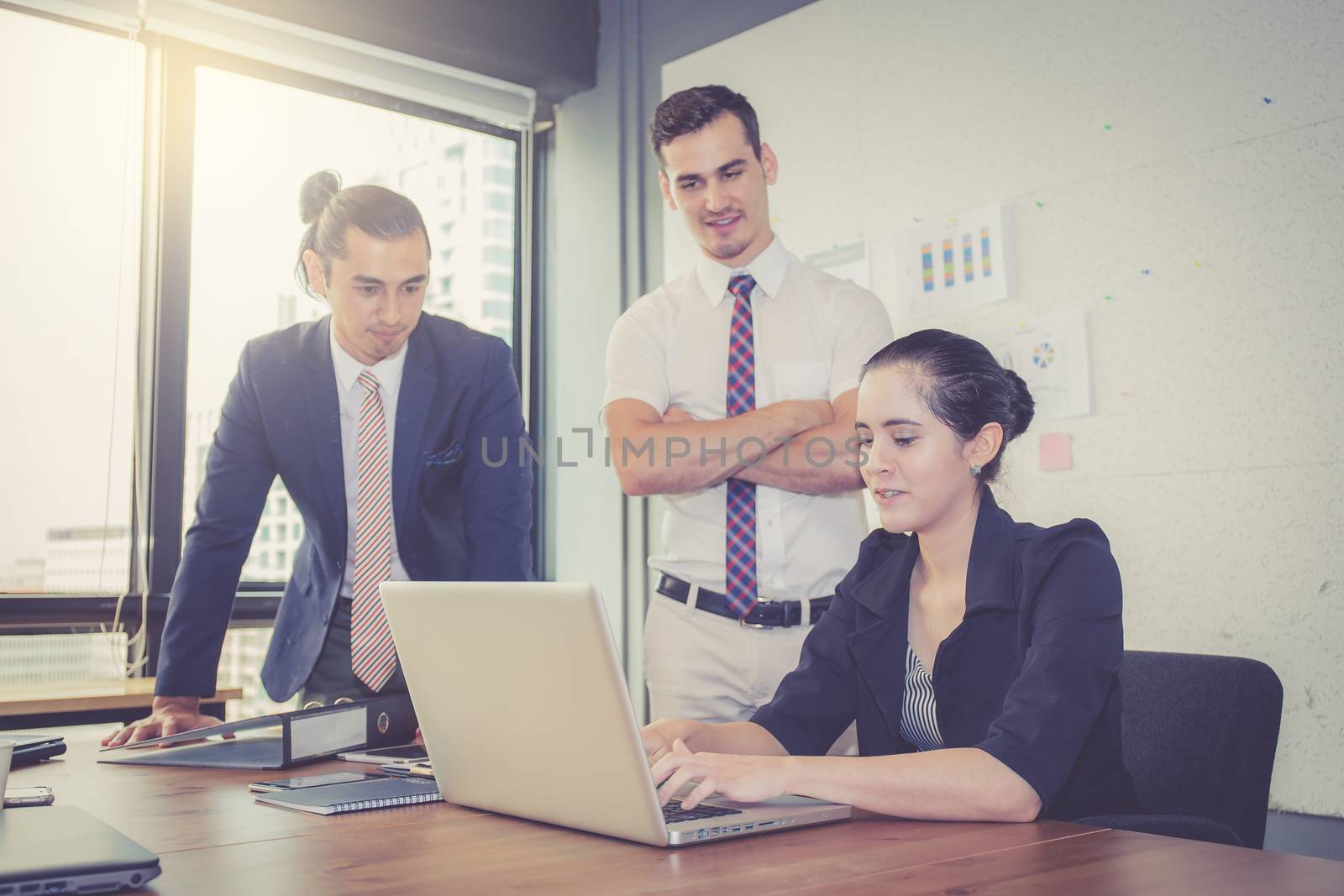 Business team having a meeting with woman using laptop during a meeting and presents 