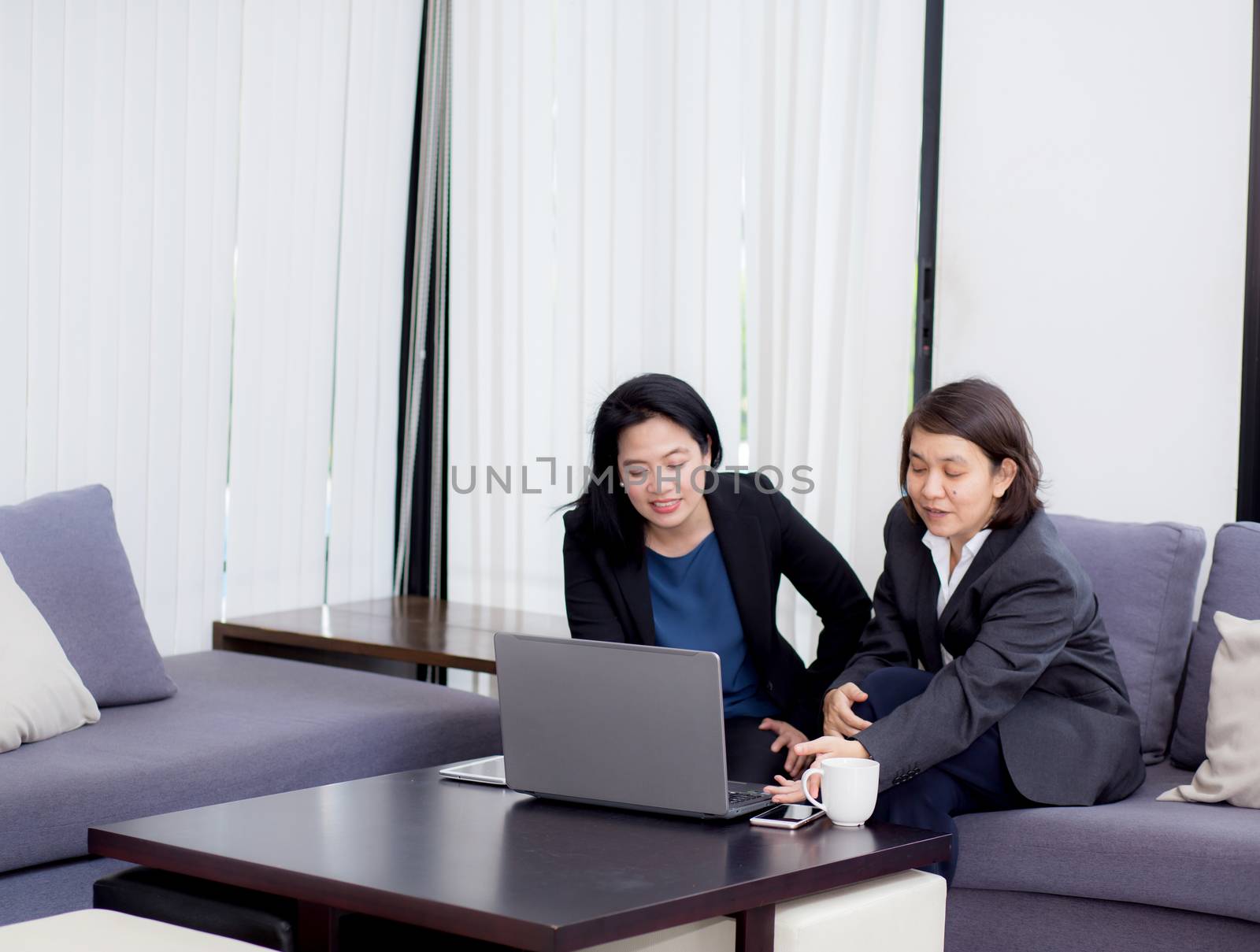 senior and junior businesswoman discuss something during their m by nnudoo