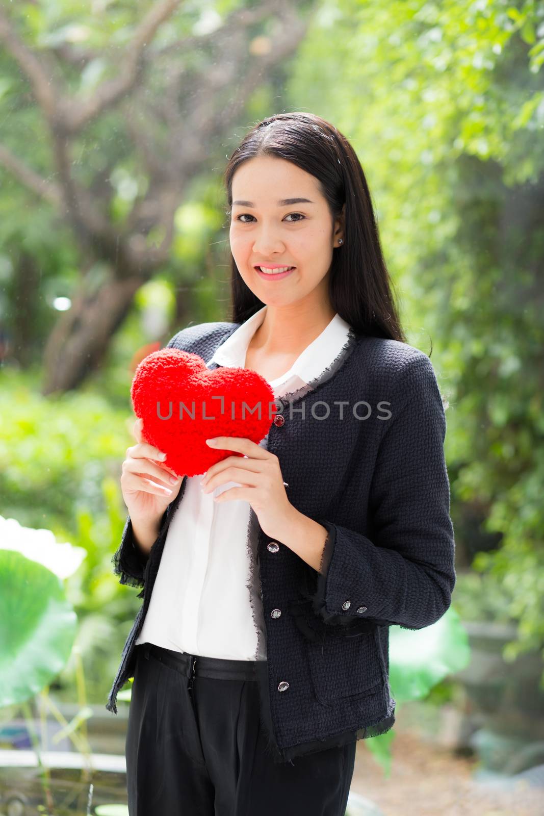 Red heart in businesswoman hand - Asian woman with hope concept.