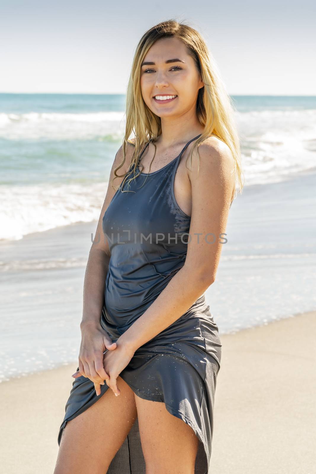 A gorgeous young blonde female enjoys a day at the beach alone