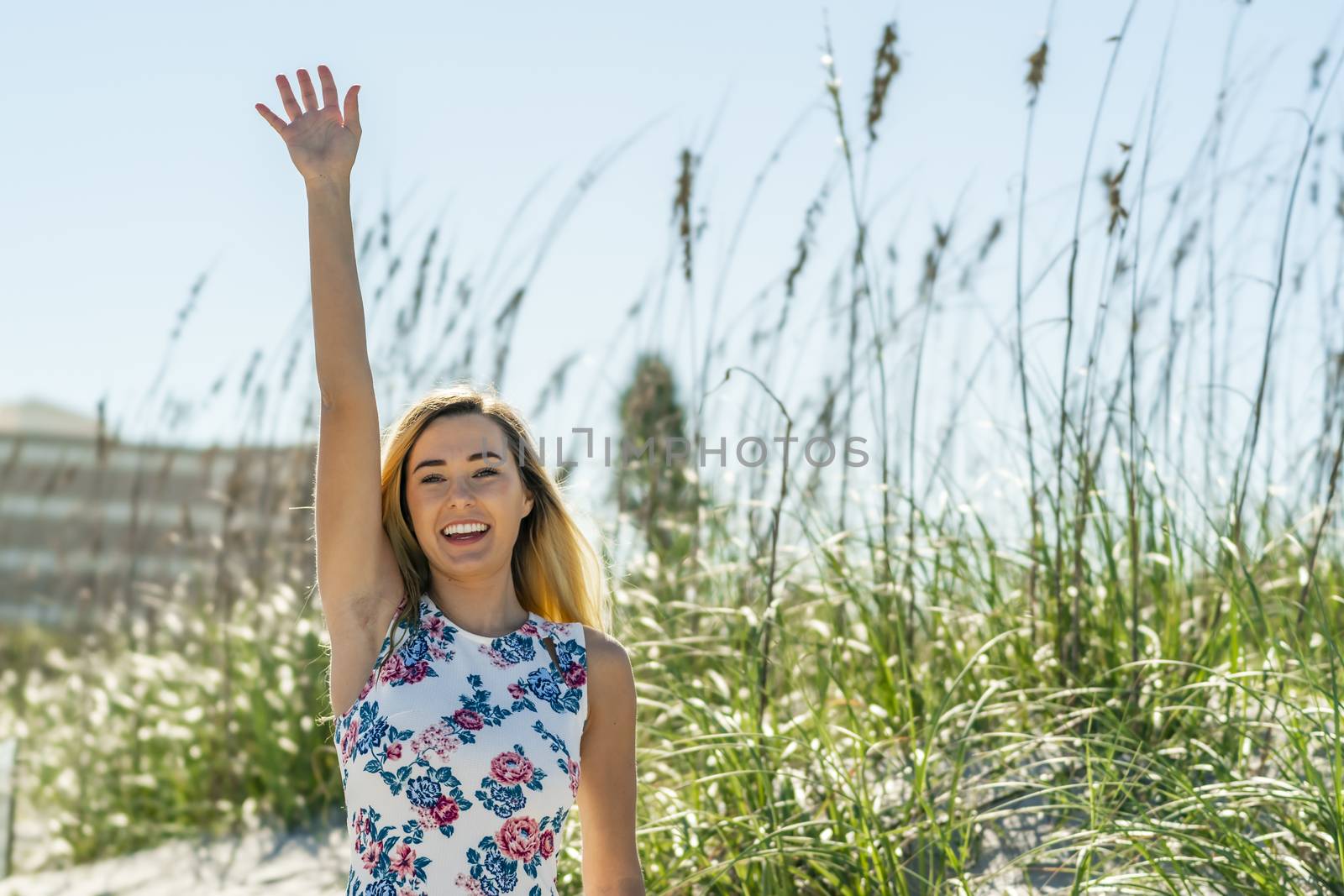 A gorgeous young blonde female enjoys a day at the beach alone