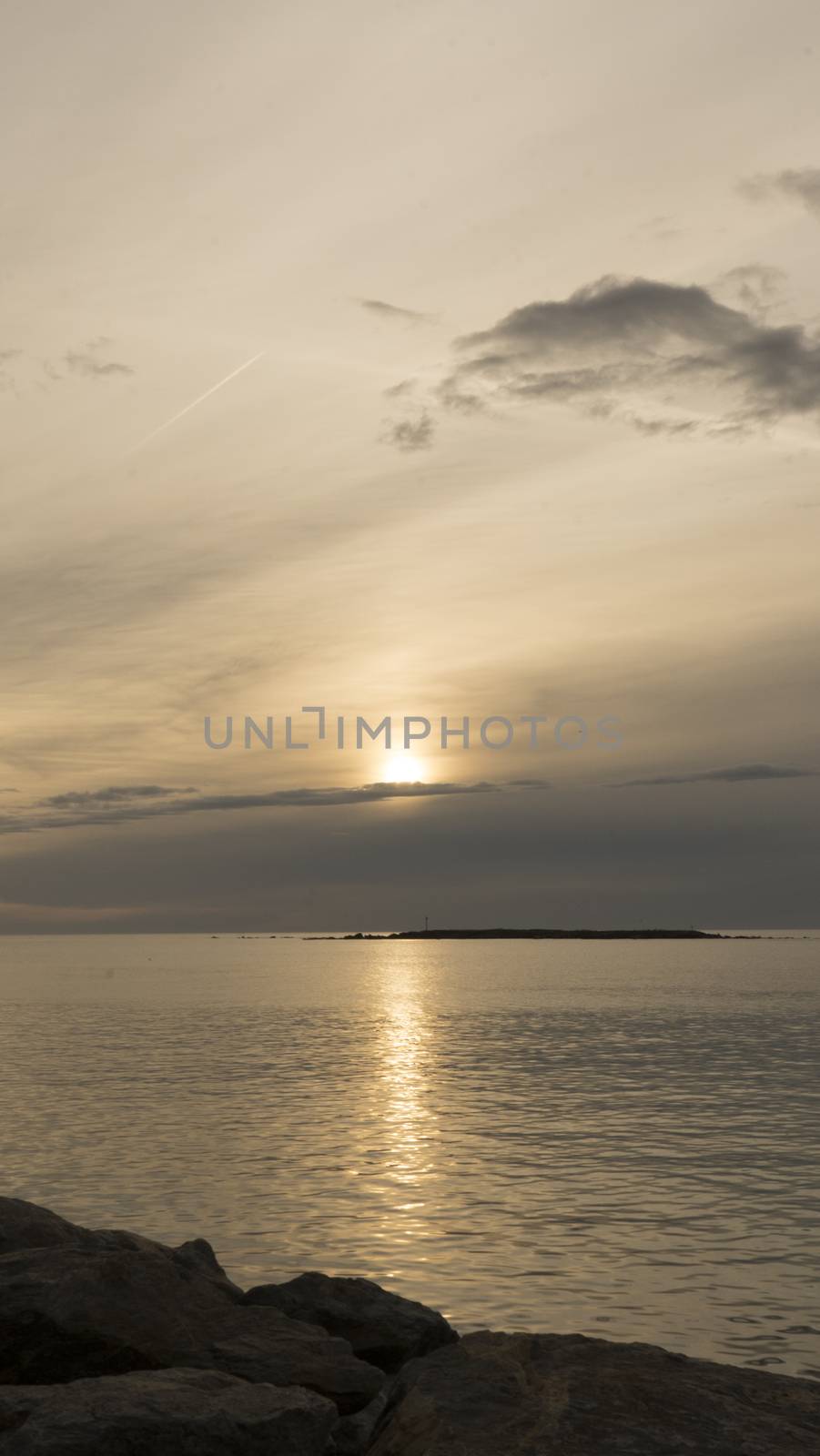 Emotional shot of a bay at sunrise or sunset in backlight with very cloudy sky by robbyfontanesi