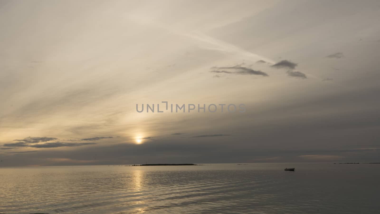 Emotional shot of a bay at sunrise or sunset in backlight with very cloudy sky