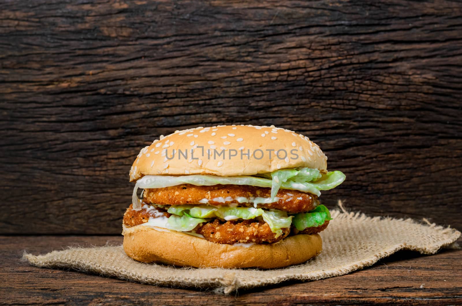 Hamburger a chicken on a wooden background by sompongtom