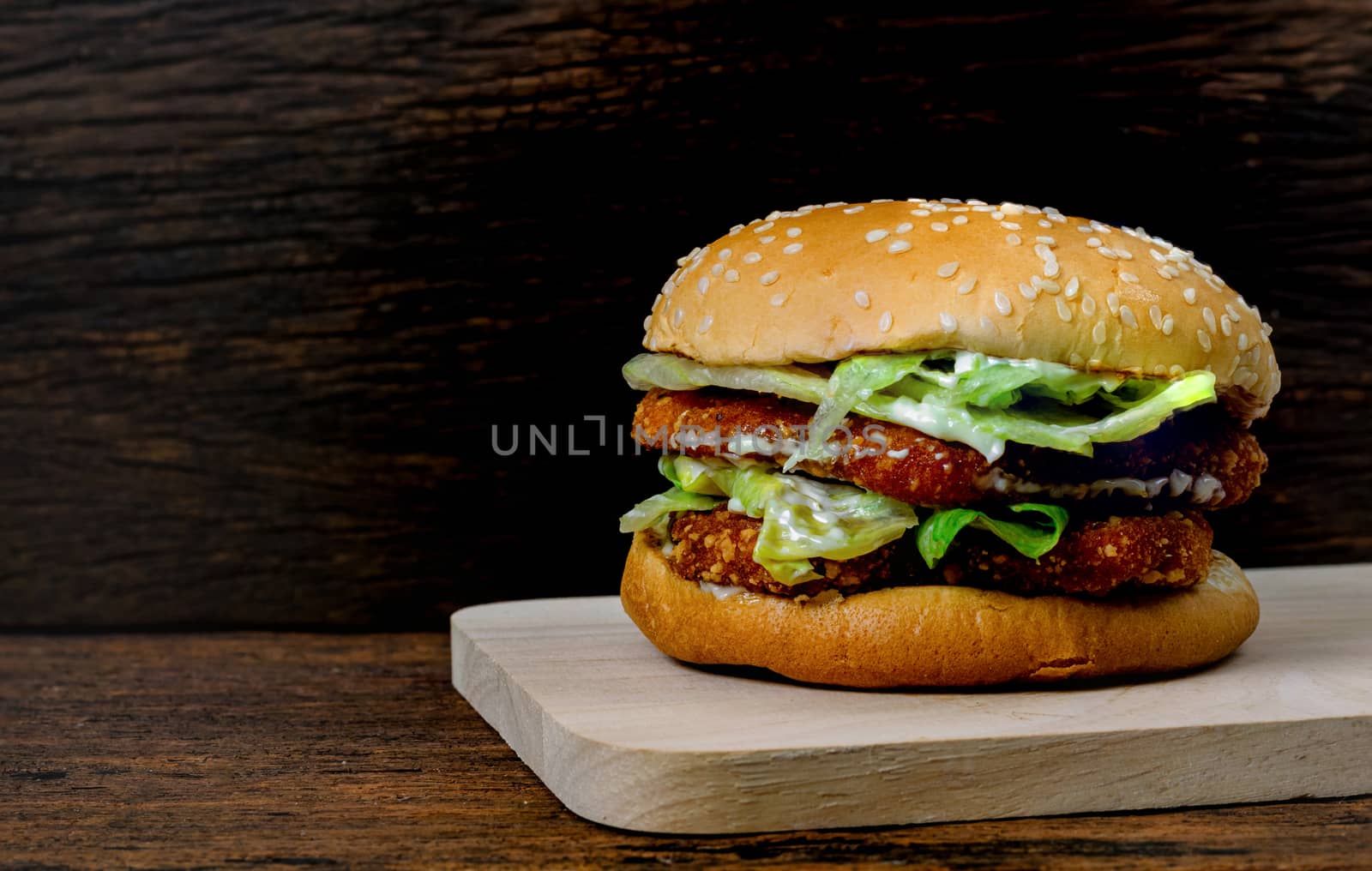 Hamburger a chicken on a wooden background by sompongtom