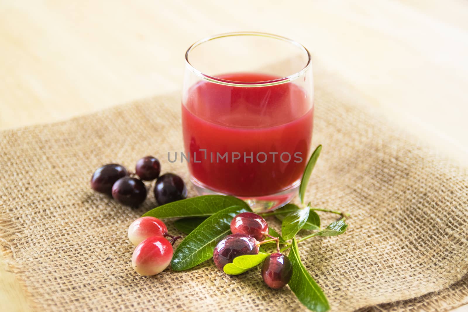 fresh Carissa carandas glass of juice with Carissa carandas fruits and Healthy drinks concept