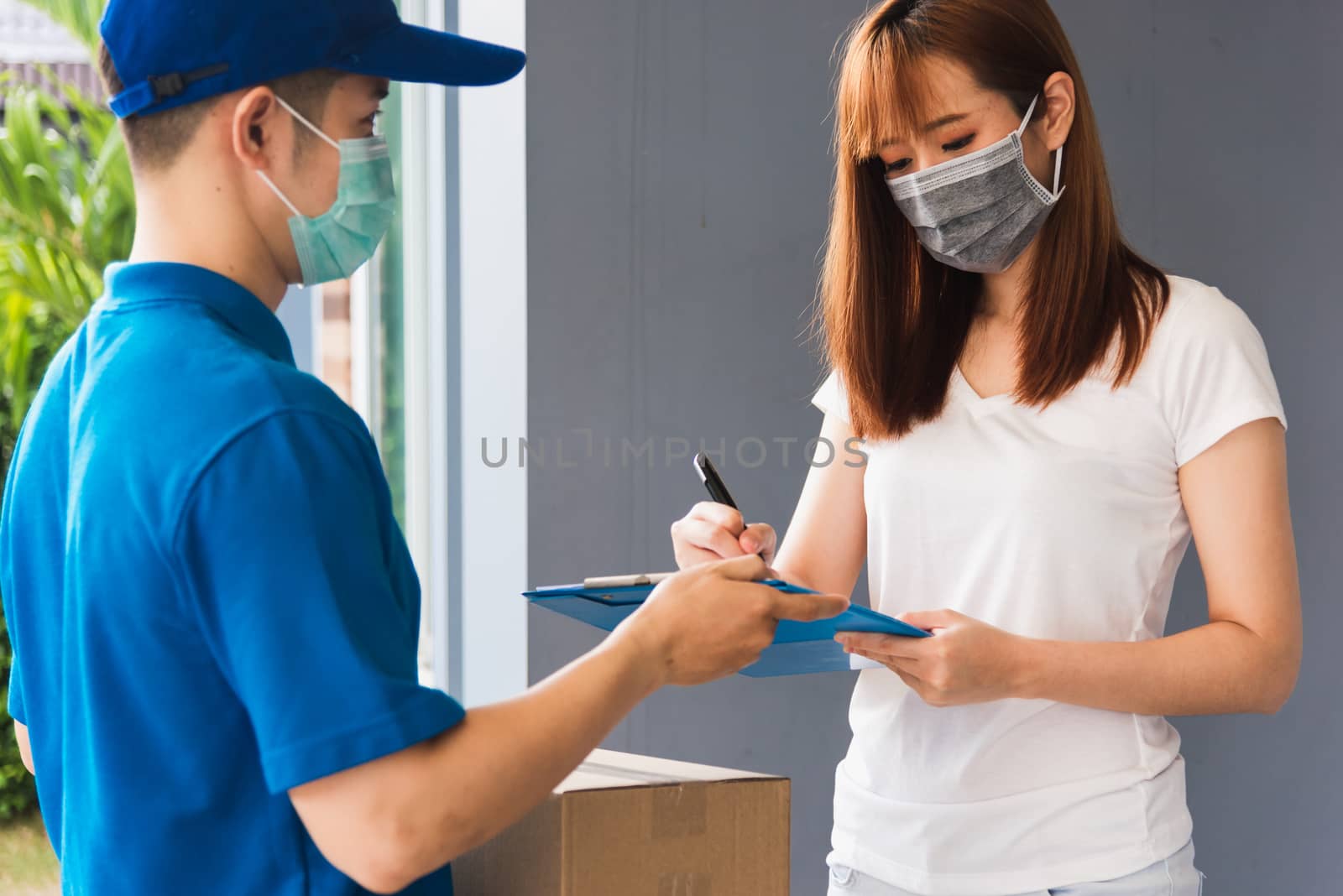 delivery man courier in uniform protective face mask coronavirus by Sorapop