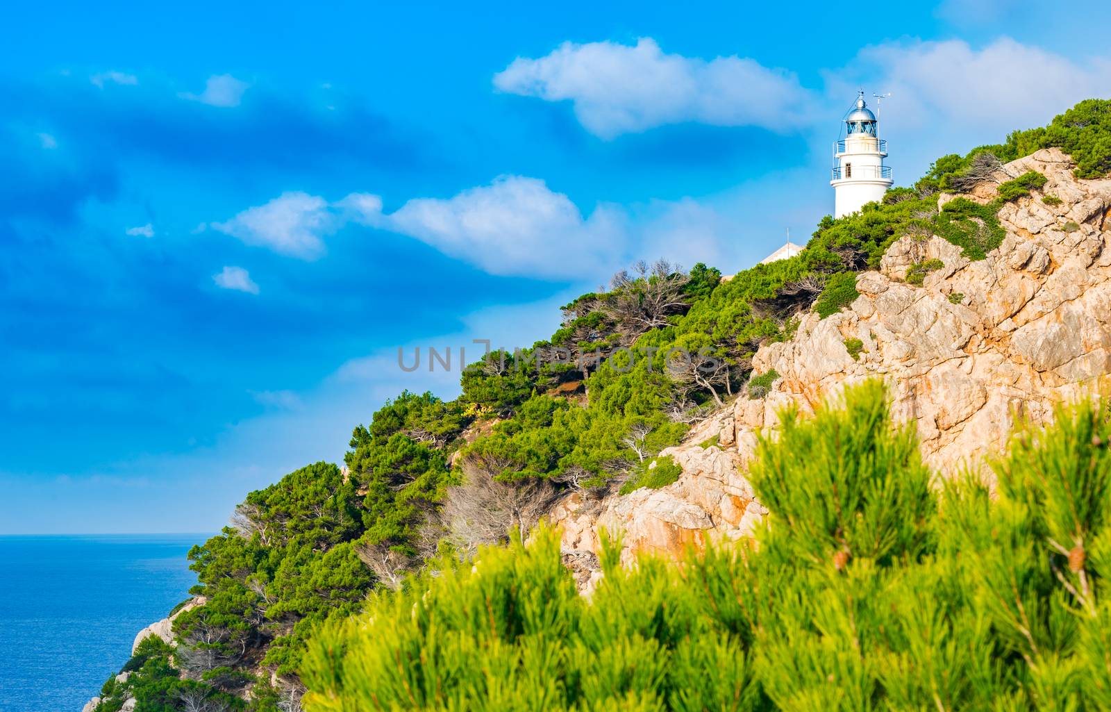 Beacon at the cliffs on Majorca island, cape at Cala Ratjada, Spain Mediterranean sea