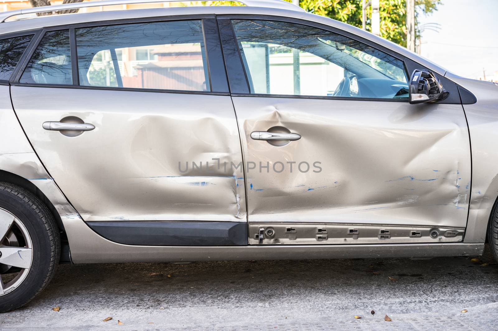 Close-up of dented car doors at car side body after car accident