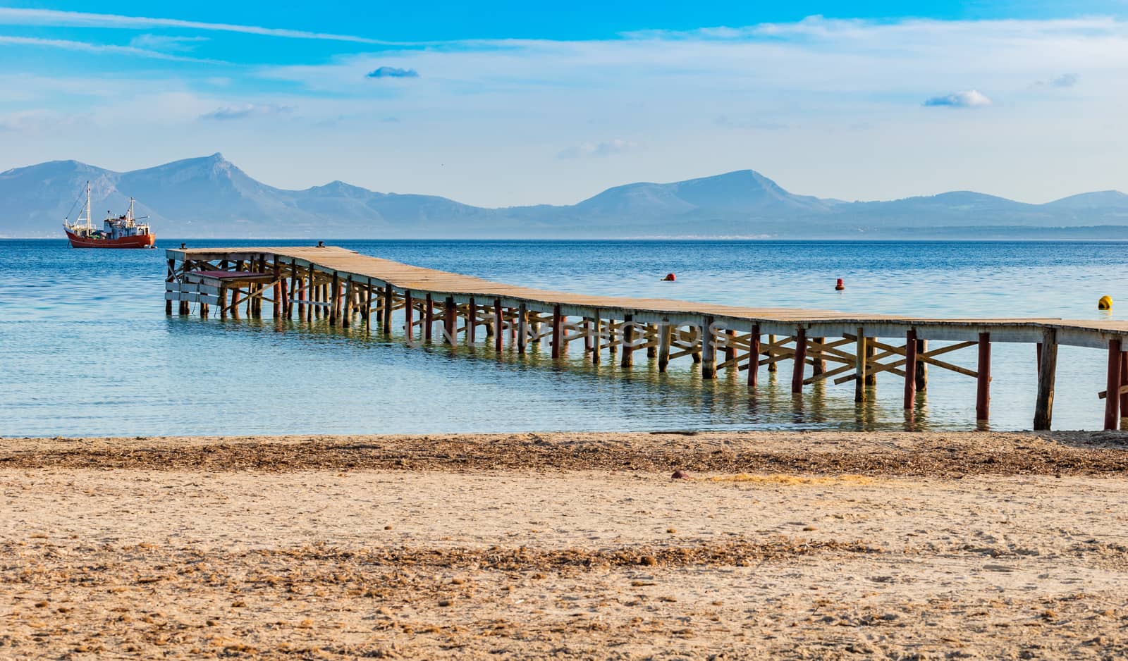 Idyllic view of the pier at the bay of Alcudia on Majorca, Spain Balearic islands