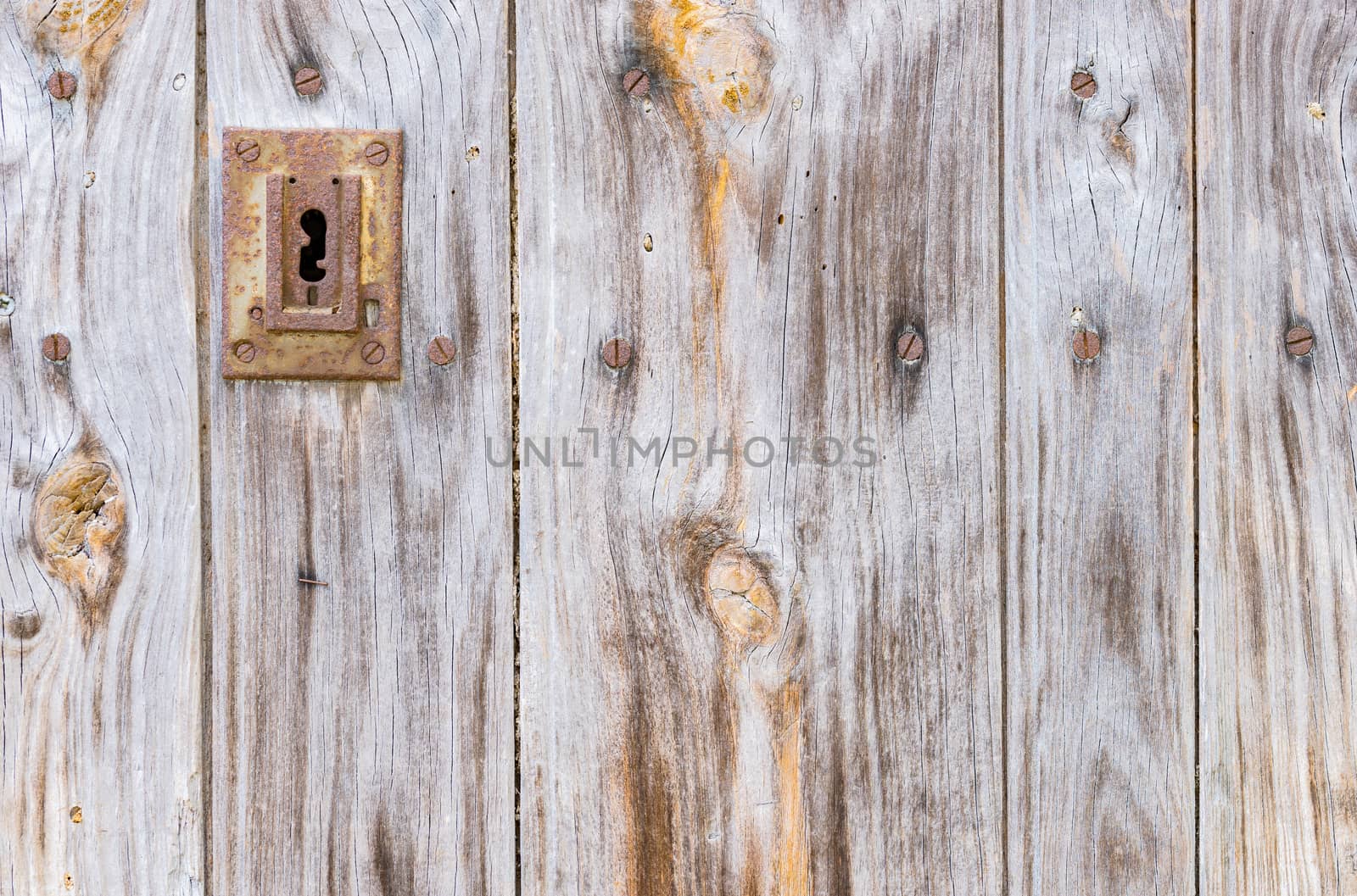 Old wooden front door with keyhole and copy space