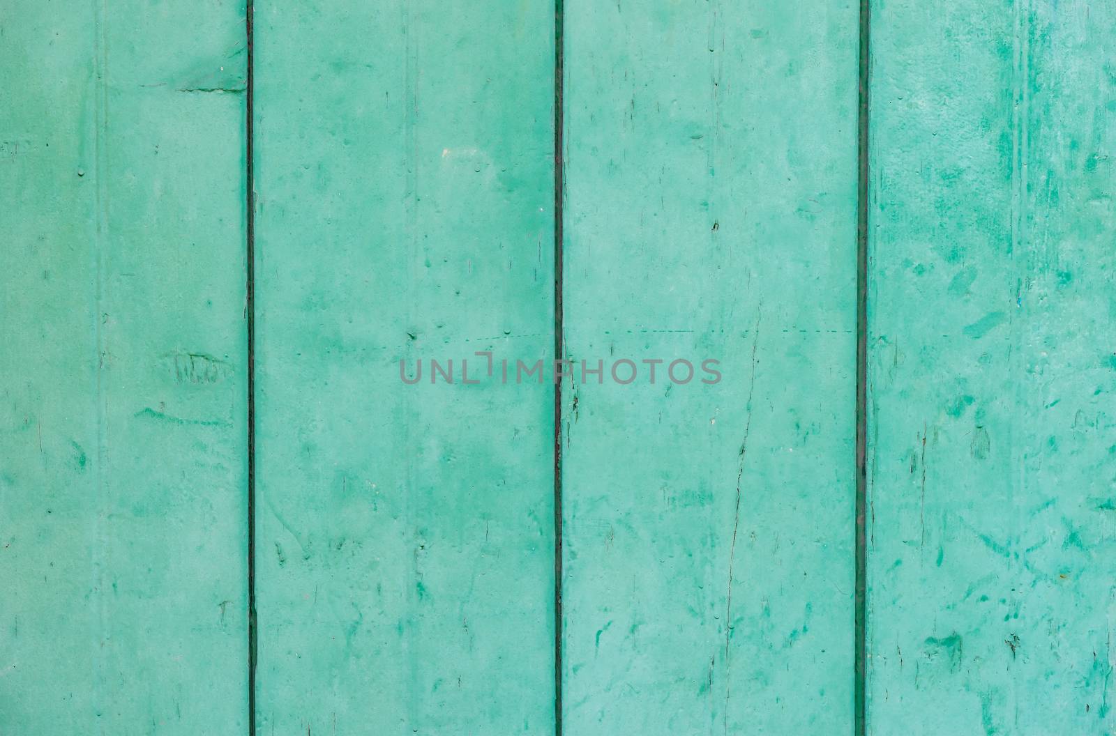 Green colored wooden planks background texture, close-up