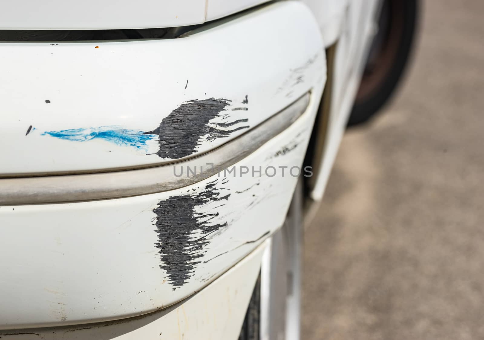 Car accident with close-up of damaged bumper 