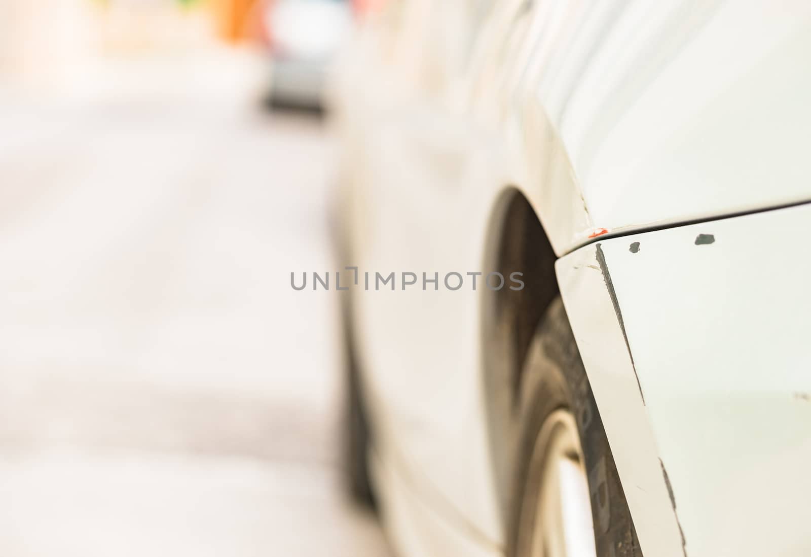 Car crash with detail view of damaged scratched bumper and fender