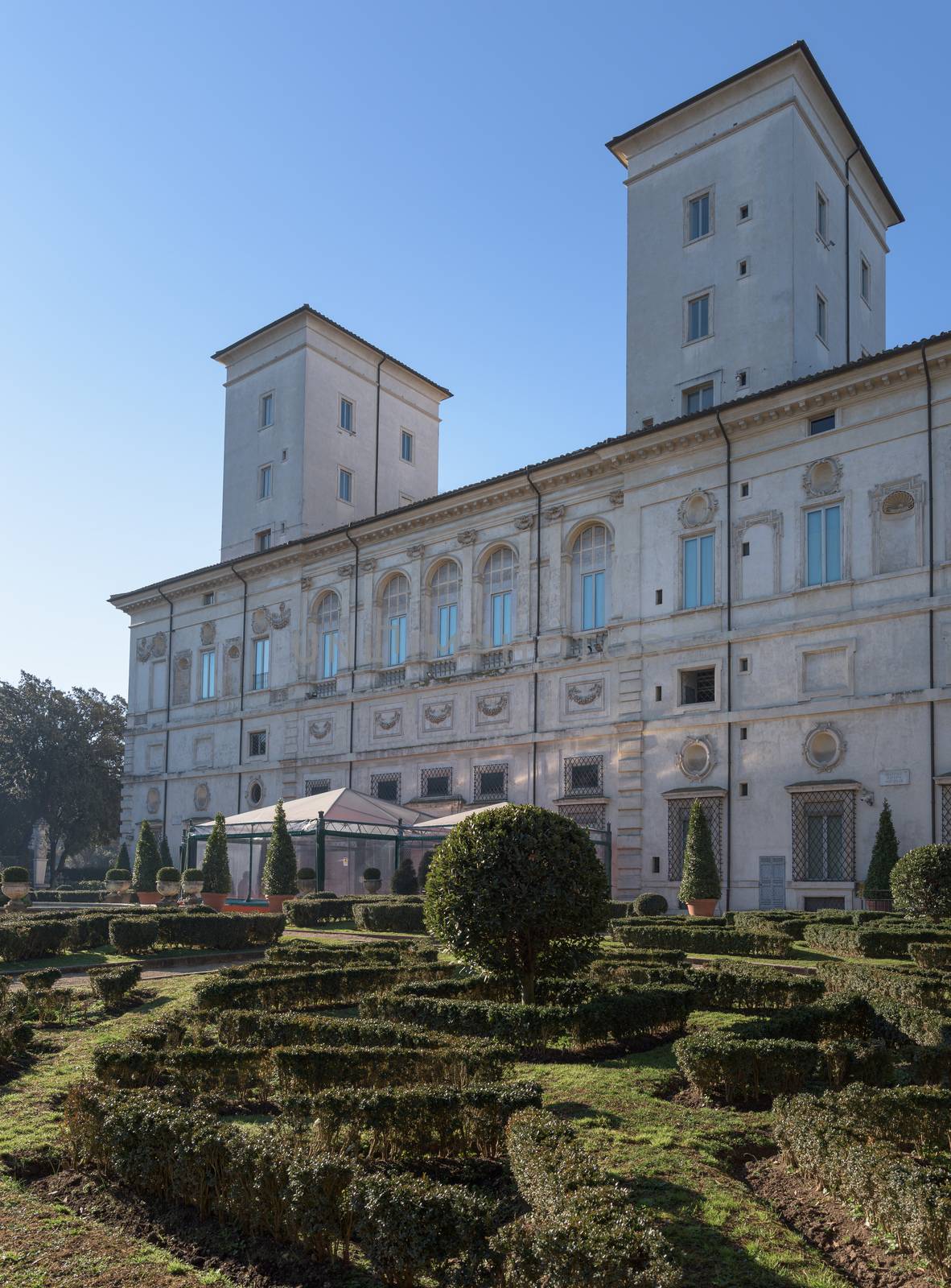 Rome, Italy - 16 Feb 2020: French gardens and elevation of the Casino Borghese, a Renaissance period rural palace, now a museum in central Villa Borghese park in Rome, Italy