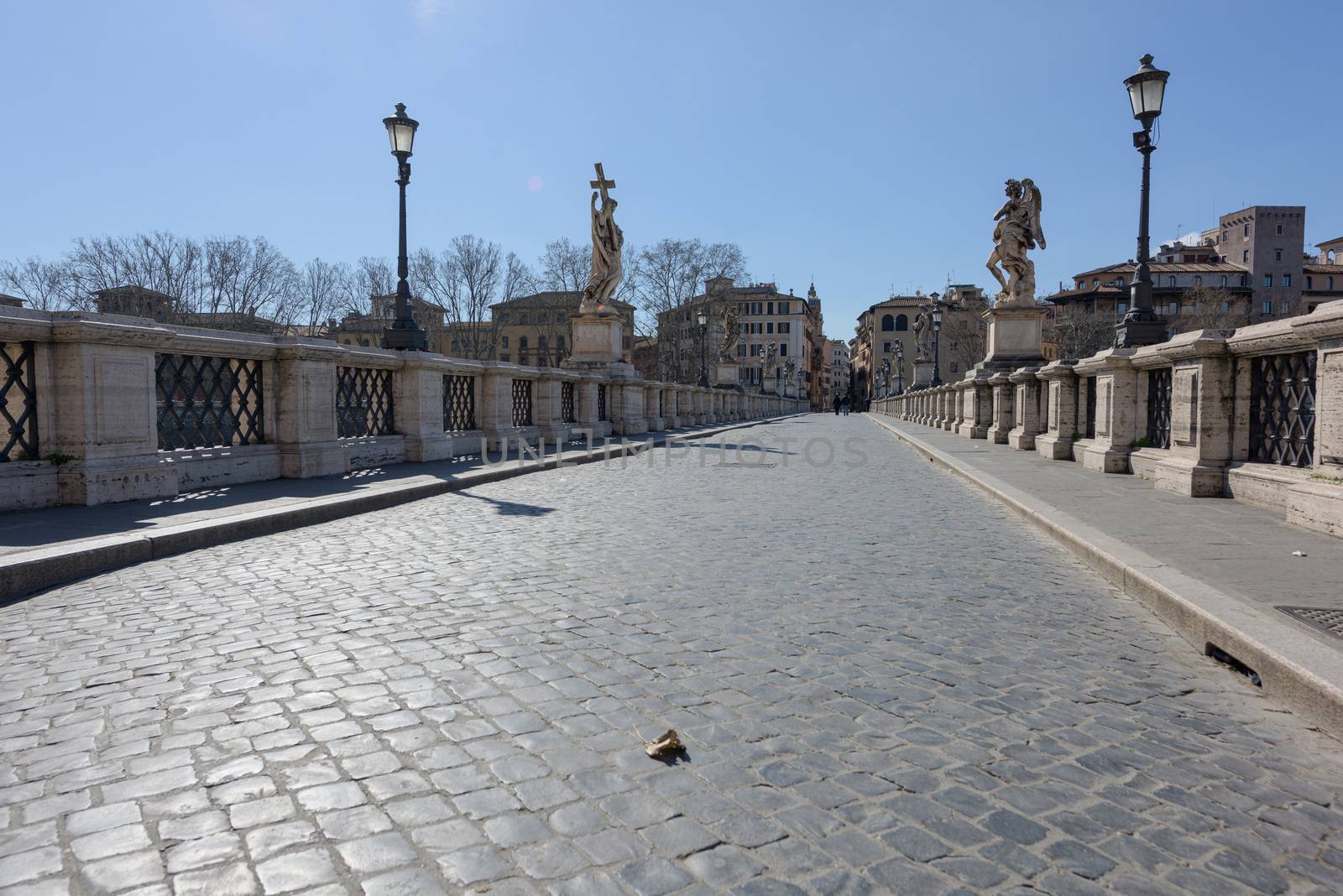 Rome, Italy - 12 March 2020: the popular tourist spot of the Sant Angelo bridge is now deserted, a rare sight in Rome, Italy. Today, the Italian government decreed a nationwide lockdown, with travel and movement bans, closing of shops, bar and restaurants, and emergency health measures following the CoVid-19 epidemic.