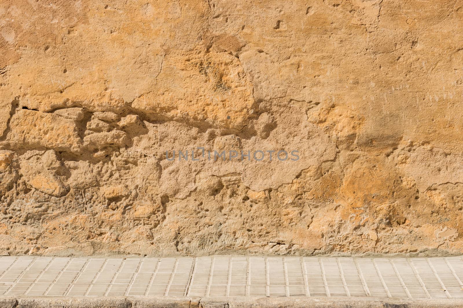 Old street wall background with sidewalk and copy space
