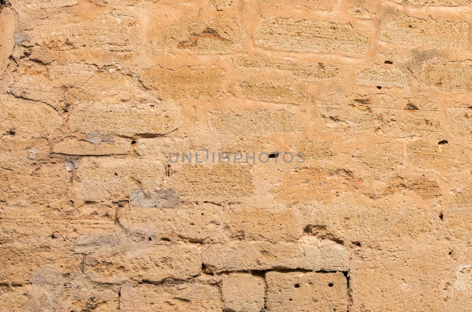 Vintage damaged stone wall background texture, close-up