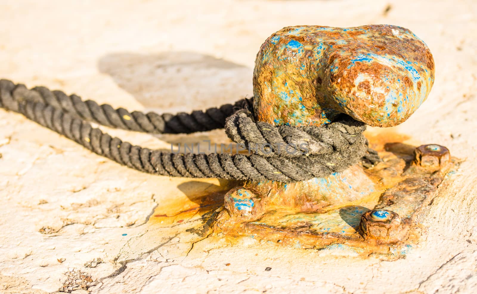 Close-up, of old rusty mooring bollard at pier