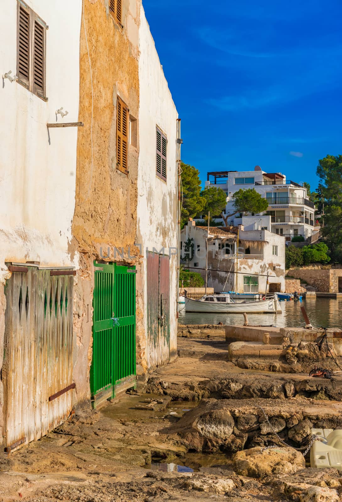 View of old fishing port in Cala Dor with boathouses on Mallorca island, Spain Mediterranean Sea