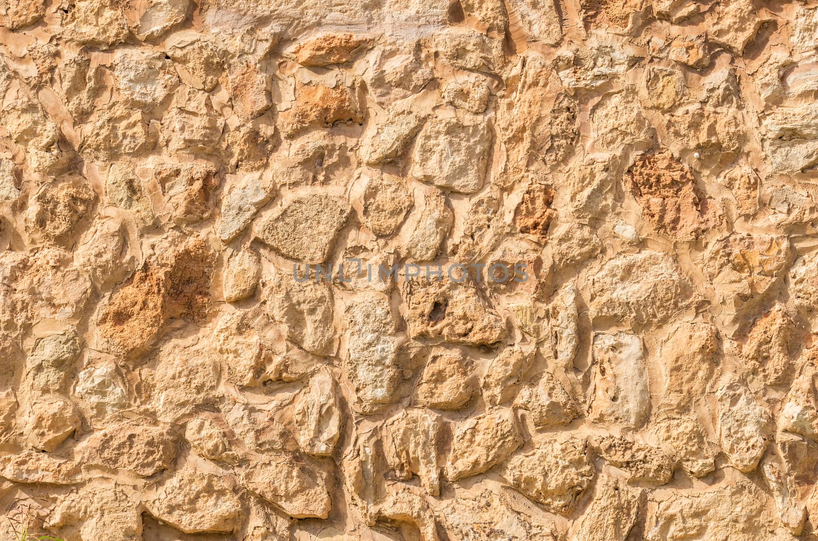 Natural brown stone wall background texture, close-up