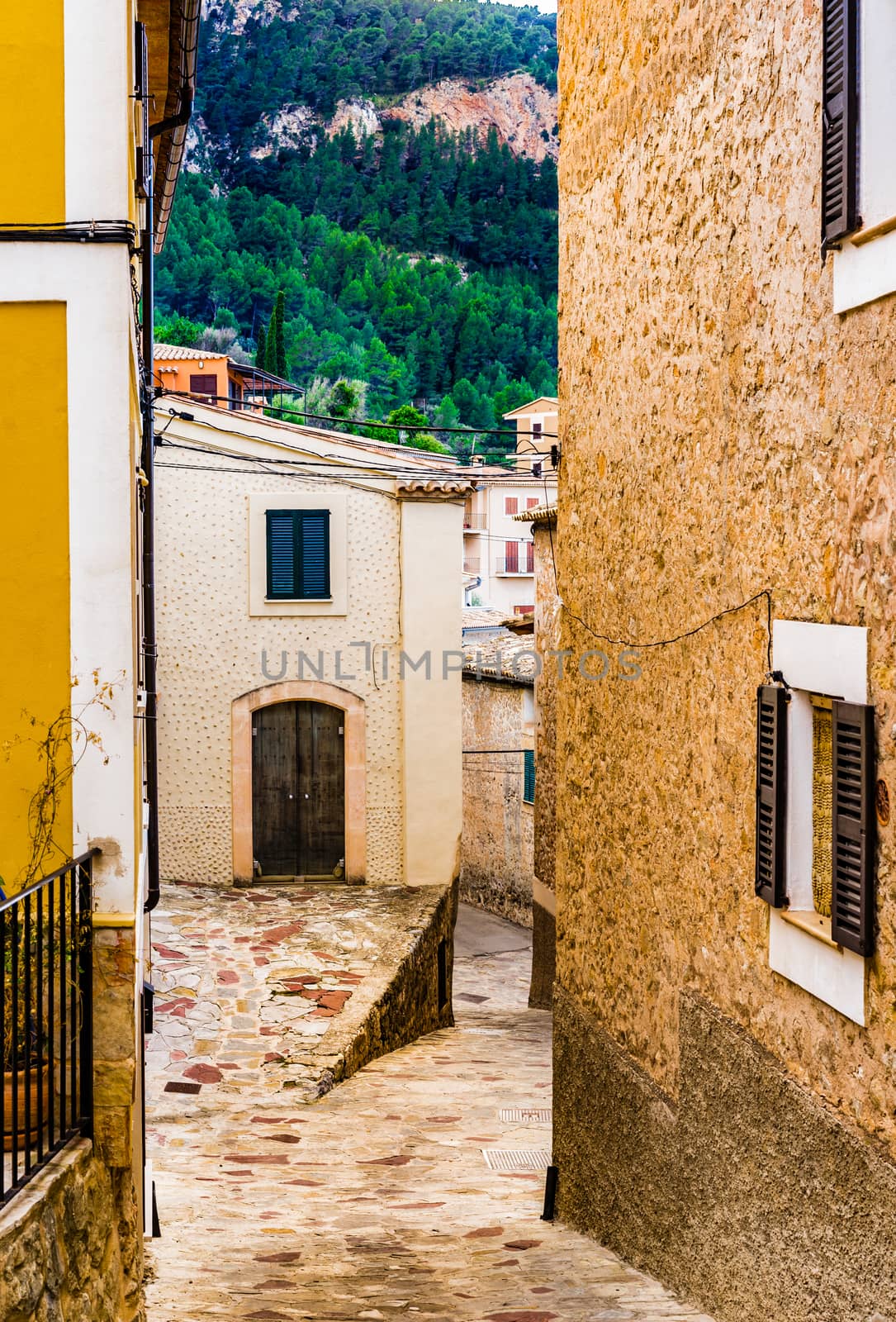 Old spanish village houses with narrow alley by Vulcano