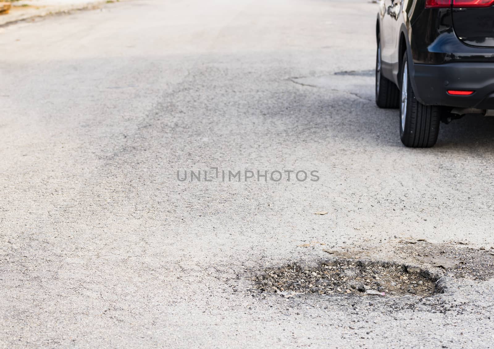 Close-up of damaged street with pot hole
