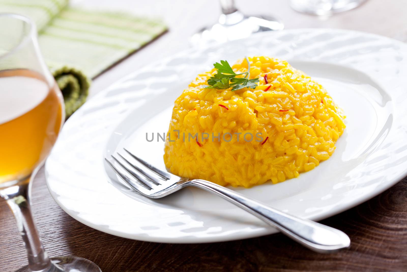 Homemade Saffron Risotto With A Glass Of Wine by mpessaris