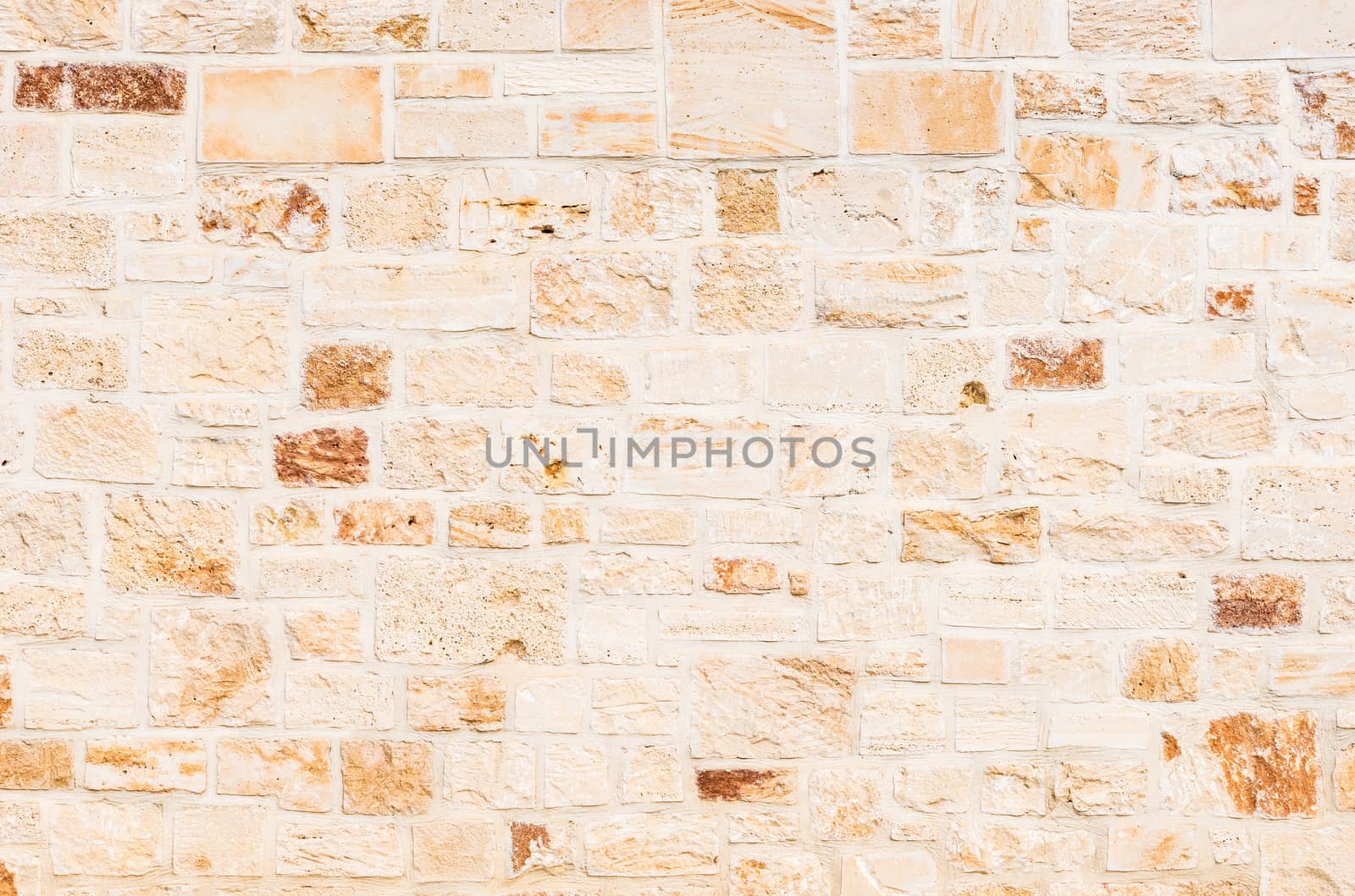 Natural light brown stone wall background texture, close-up