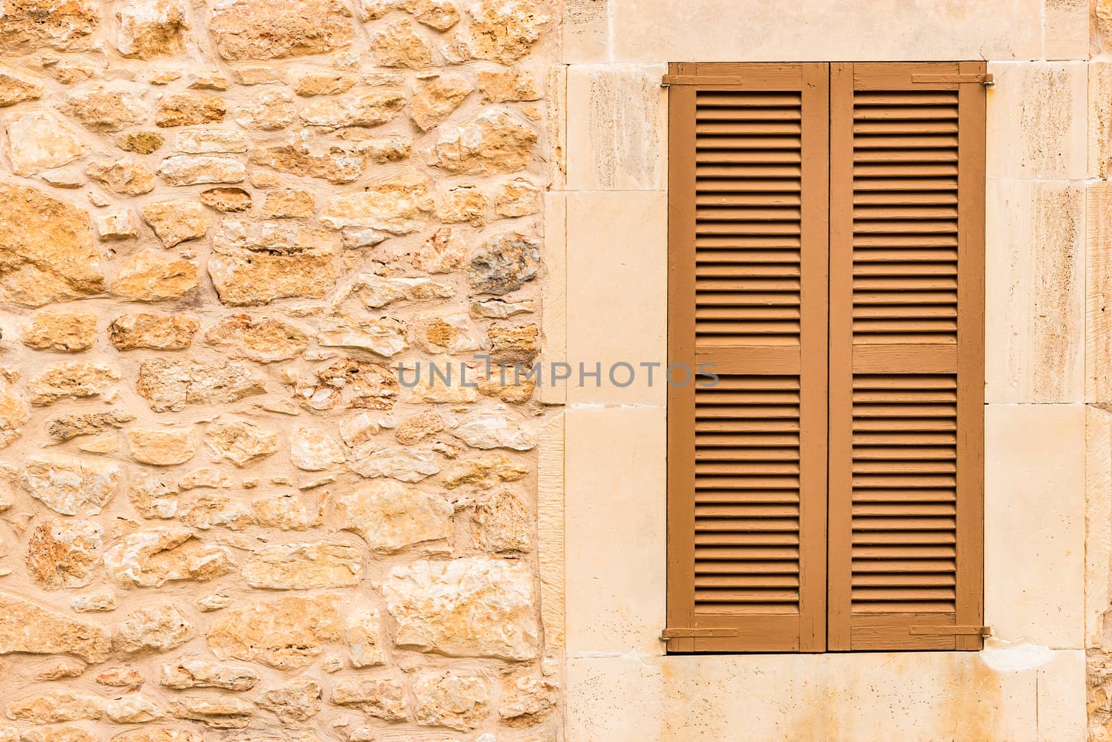 Old mediterranean window shutters and wall background 