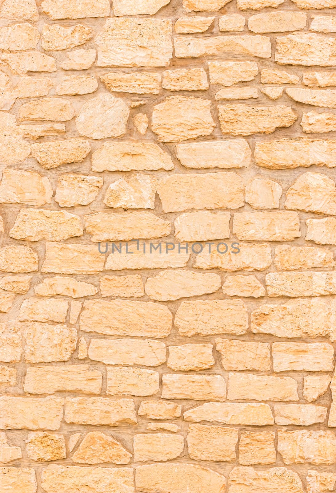 Natural brown stone wall background texture, close-up