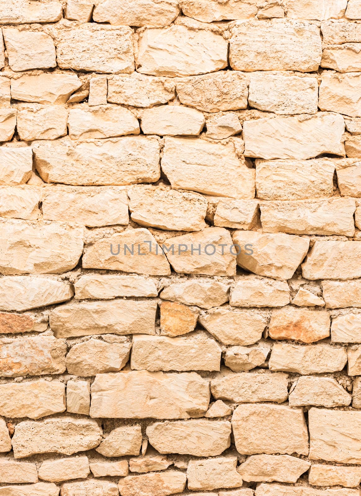 Rustic old light brown stone wall texture background structure